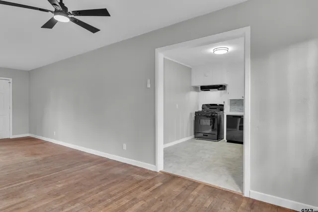 a view of a kitchen with a sink and a refrigerator