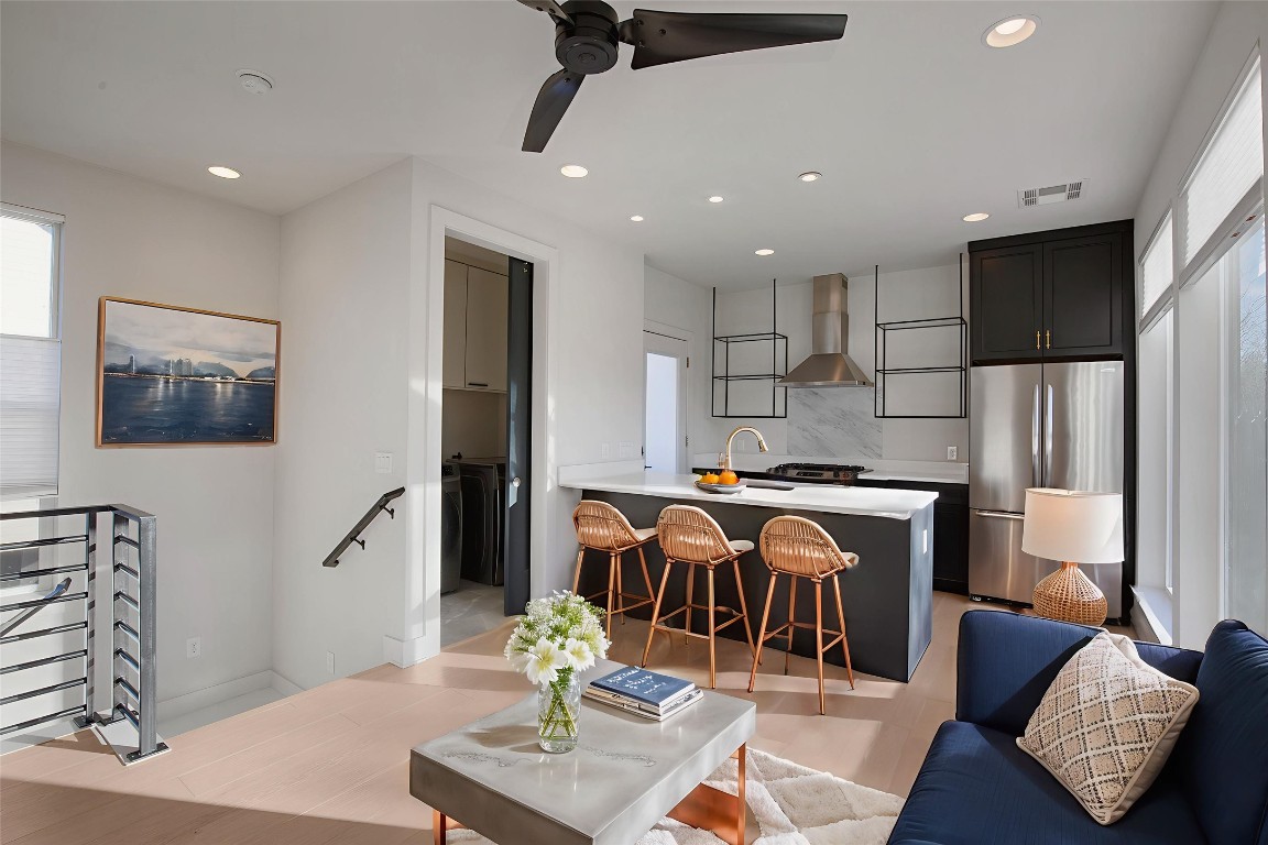 a living room with furniture and wooden floor