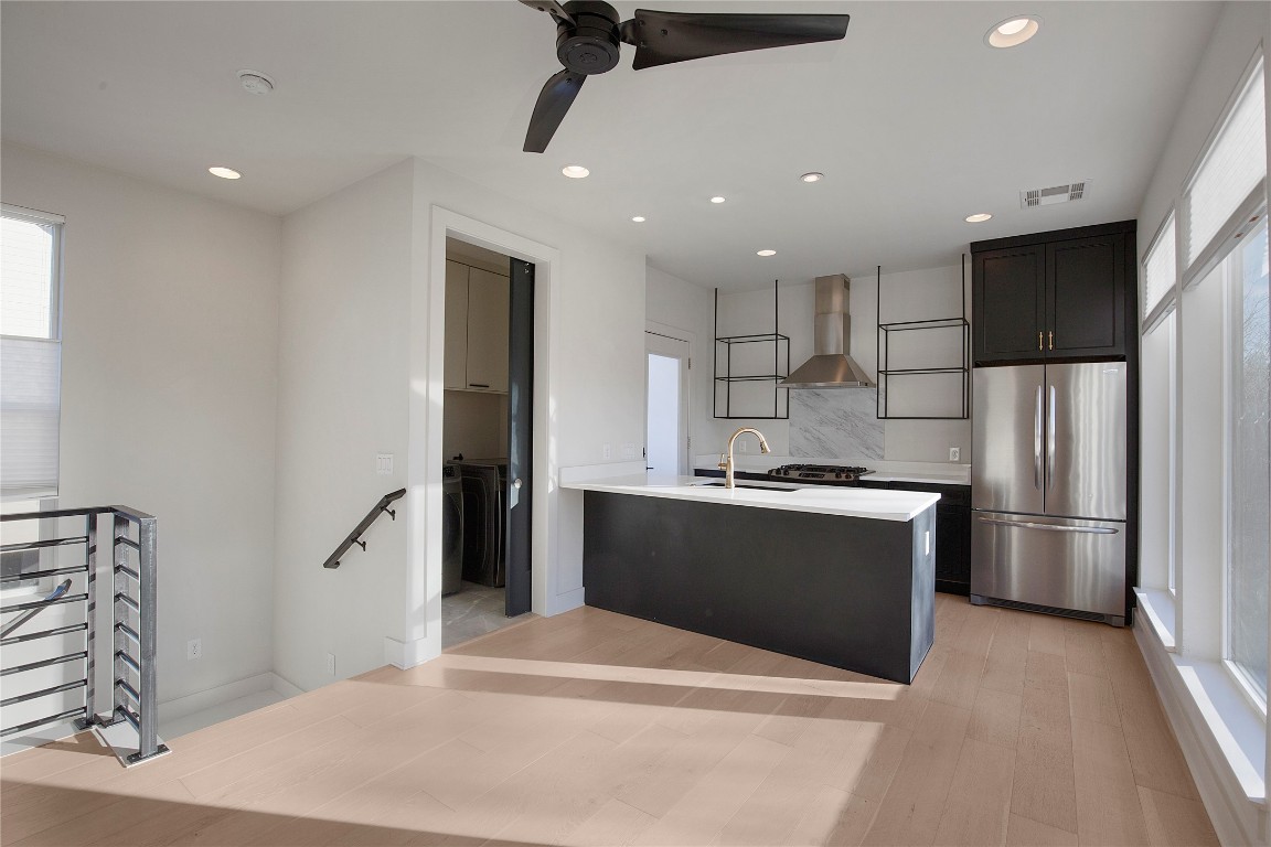 1708 Perez Street, Unit B Austin, TX 78721 - Photo 2 of 19 a kitchen with stainless steel appliances kitchen island a refrigerator sink and stove