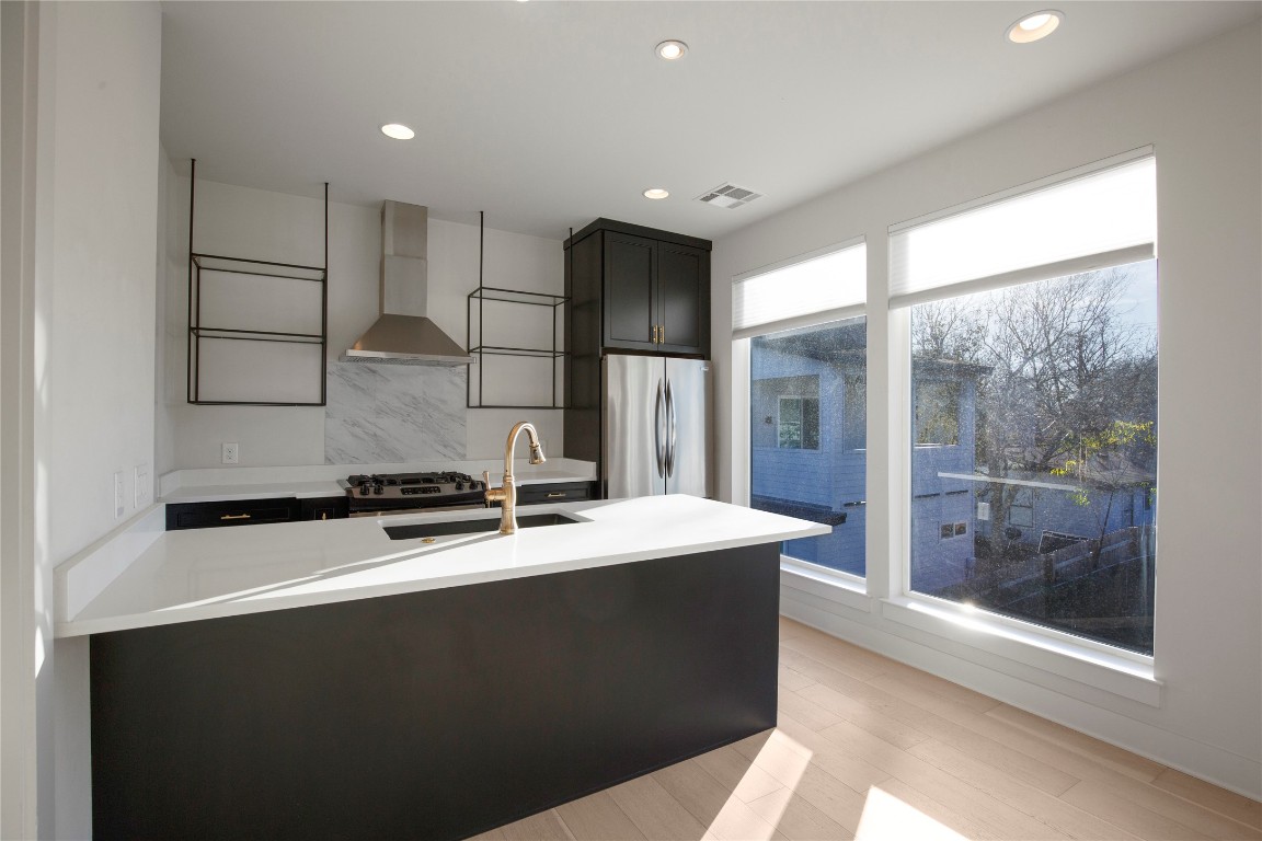 1708 Perez Street, Unit B Austin, TX 78721 - Photo 3 of 19 a kitchen with stainless steel appliances a sink a stove a refrigerator a counter top space and cabinets