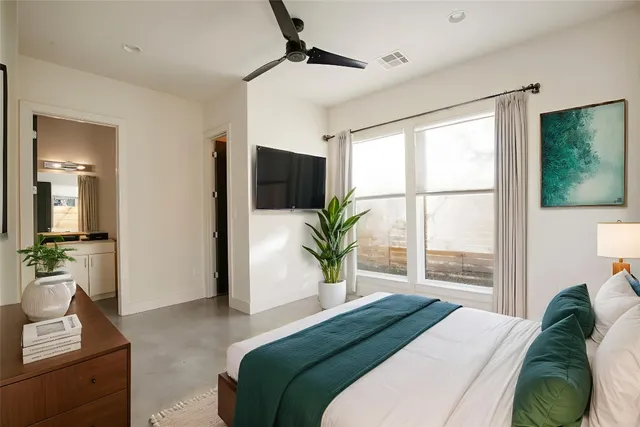 a bedroom with a large bed and a window