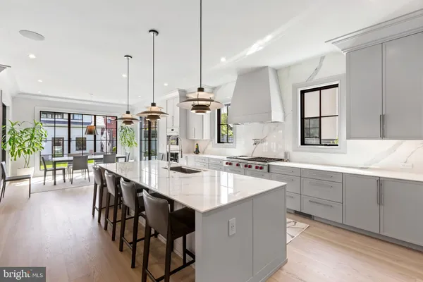 a kitchen with center island table and chairs