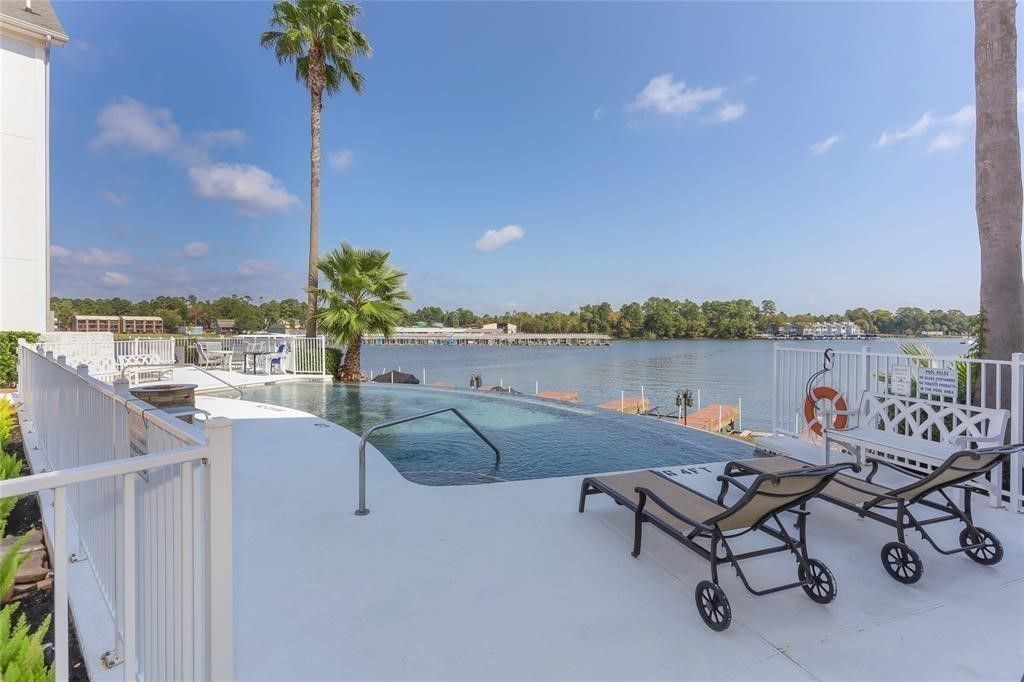 168 Lake Point Boulevard, Unit A102 Conroe, TX 77356 - Photo 2 of 7 a terrace with outdoor seating and city view