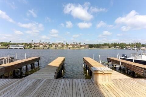 168 Lake Point Boulevard, Unit A102 Conroe, TX 77356 - Photo 3 of 7 a view of a rooftop deck with lounge chairs on th terrace