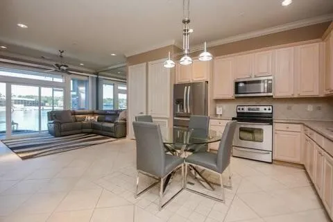 a kitchen with stainless steel appliances kitchen island granite countertop a stove and a refrigerator