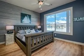 a bed sitting in a bedroom next to a window