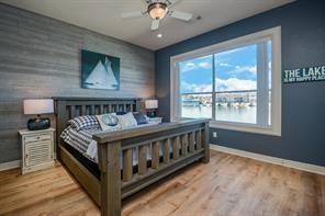 168 Lake Point Boulevard, Unit A102 Conroe, TX 77356 - Photo 6 of 7 a bed sitting in a bedroom next to a window