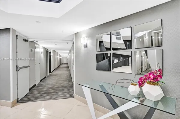 a hallway with dining table and chairs
