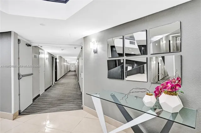 a hallway with dining table and chairs