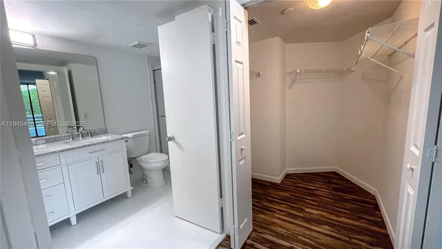 a bathroom with a double vanity sink toilet and shower