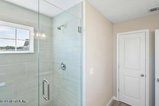 a bathroom with a shower and a sink