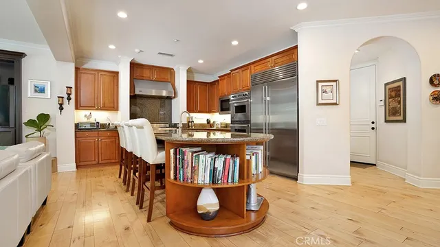 a open kitchen with granite countertop a sink a counter top space and living room view