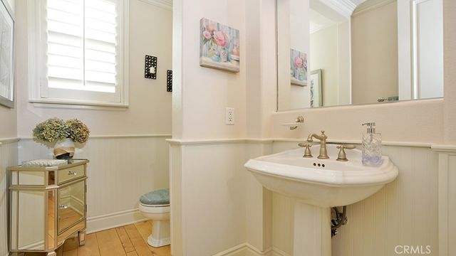 a bedroom with a bed a flat screen tv and a fireplace