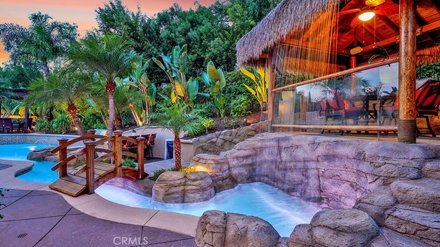 a front view of a house with a porch and a garden