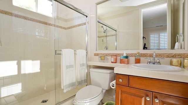 a view of a patio with table and chairs and wooden fence