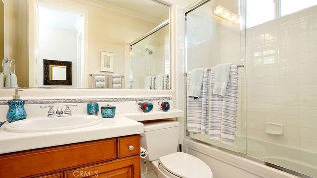 a view of a patio with couches table and chairs and potted plants