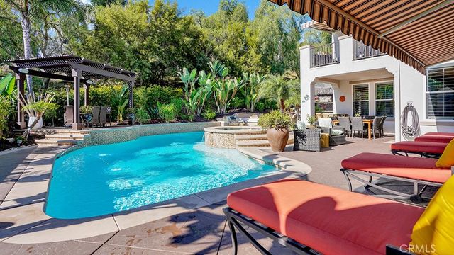 a view of a swimming pool with sitting area and furniture