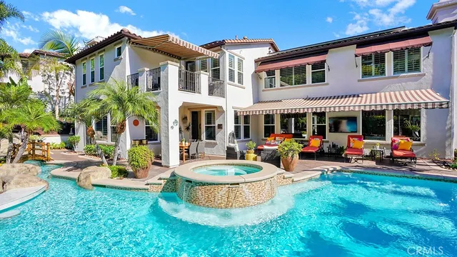 a front view of a house with a yard and potted plants