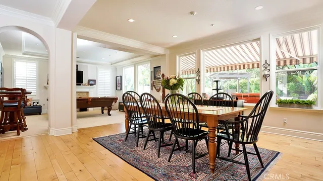 a living room with furniture a large window and a table