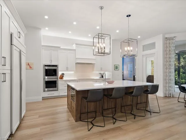 a large kitchen with a table and chairs