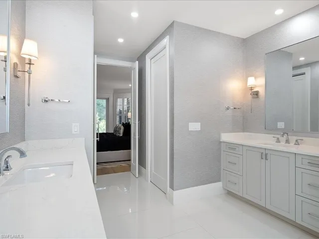 a spacious bathroom with a bathtub shower sink and mirror