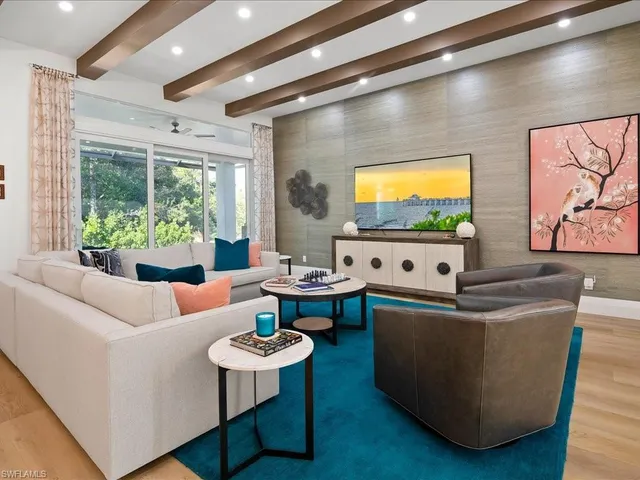 a living room with couches and a flat screen tv