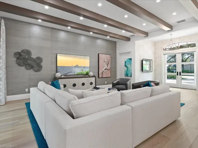 a living room with couches and a flat screen tv