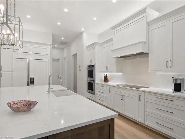 a kitchen with stainless steel appliances granite countertop a sink and cabinets