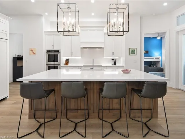 a kitchen with granite countertop a counter space dining table and chairs