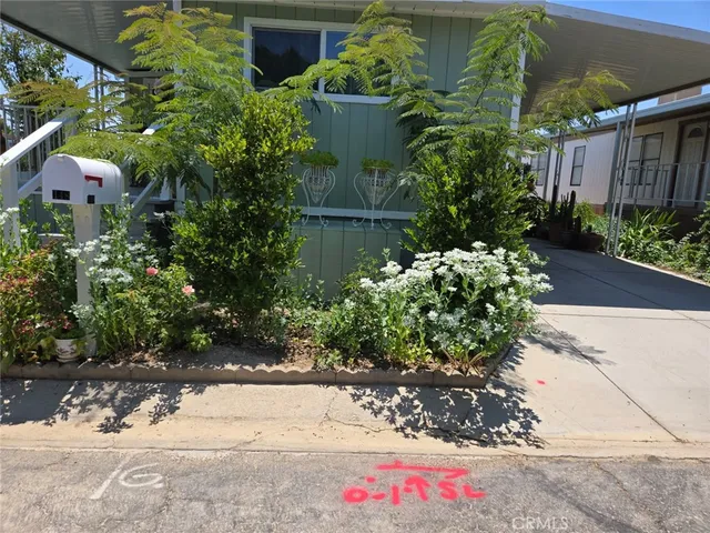 a front view of multi story residential apartment building with yard