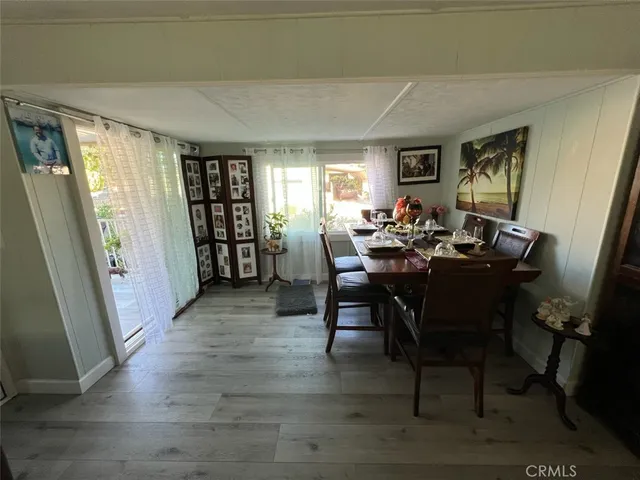 a view of a dining room with furniture window and wooden floor