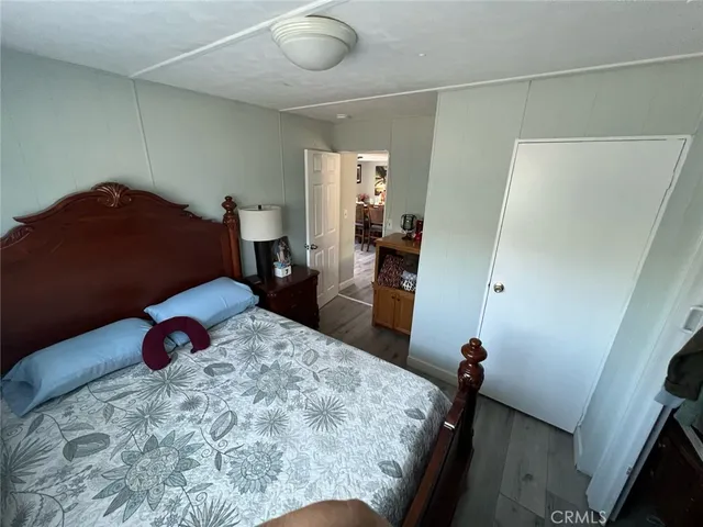 a bedroom with a bed next to a window