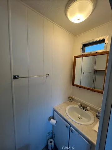 a white toilet sitting next to a bathroom sink