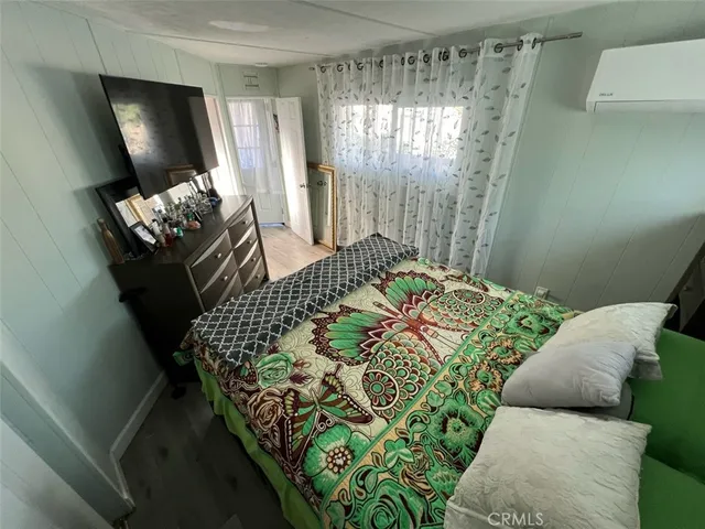 a bed room with a bed and a dresser