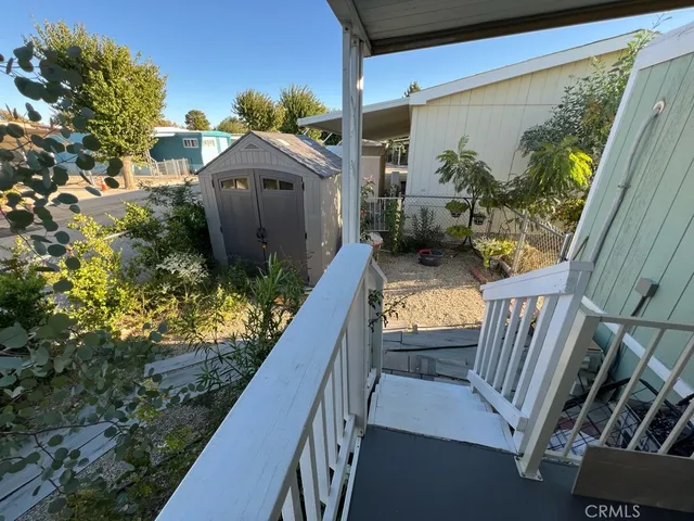 a backyard of a house with potted plants