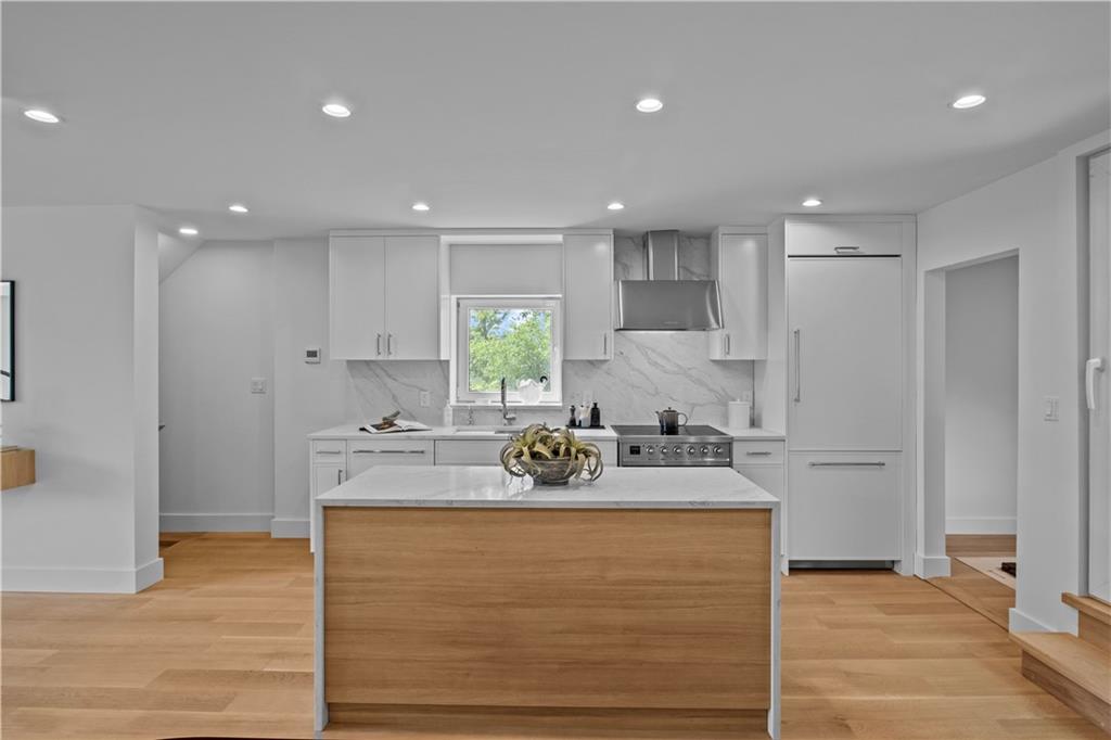 401 18th Street Brooklyn, NY 11215 - Photo 6 of 17 a kitchen with stainless steel appliances granite countertop a sink a stove a refrigerator and white cabinets