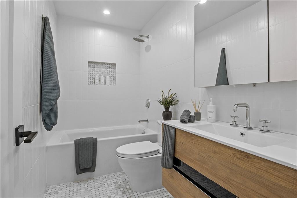 401 18th Street Brooklyn, NY 11215 - Photo 7 of 17 a bathroom with a sink a toilet and tub