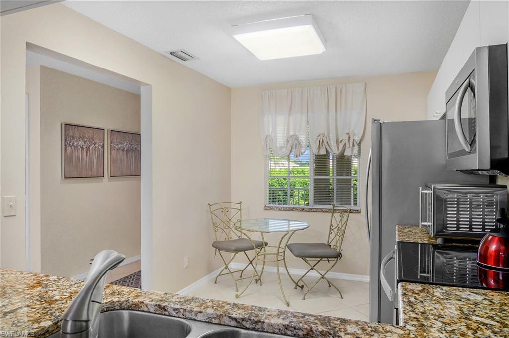 7754 Emerald Circle, Unit T202 Naples, FL 34109 - Photo 13 of 22 a living room with furniture