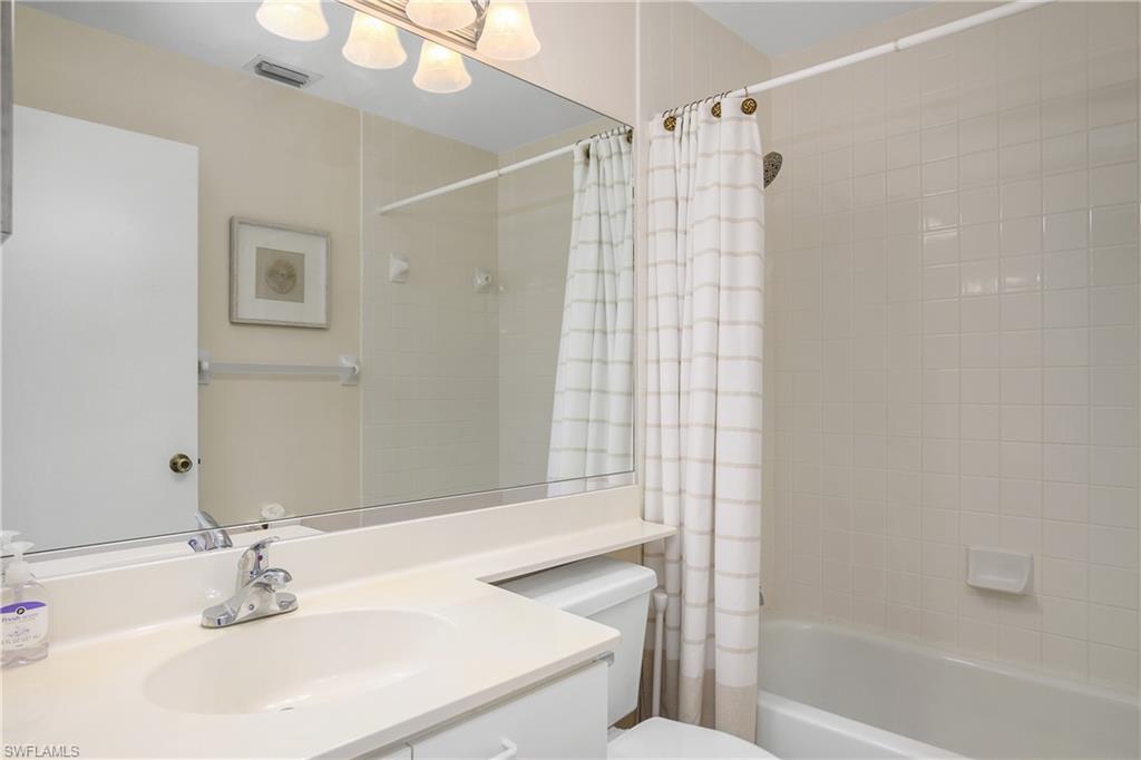 7754 Emerald Circle, Unit T202 Naples, FL 34109 - Photo 18 of 22 a bathroom with a sink and a mirror