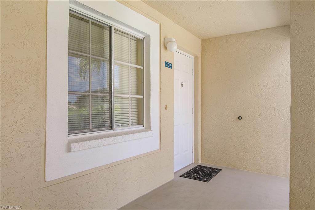 7754 Emerald Circle, Unit T202 Naples, FL 34109 - Photo 20 of 22 a view of an empty room with a window
