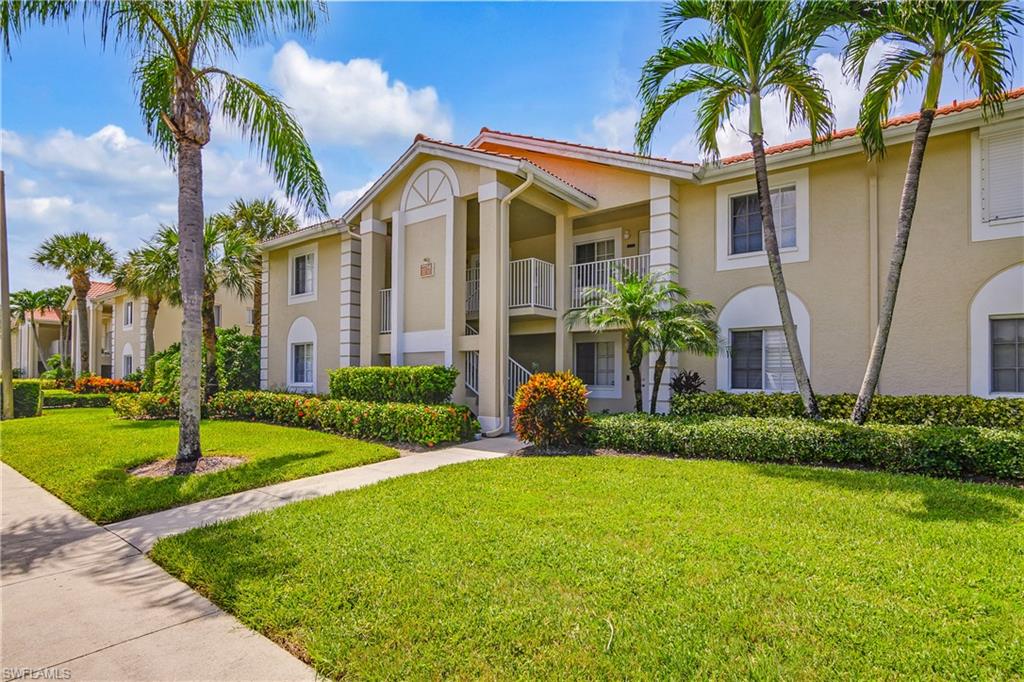 7754 Emerald Circle, Unit T202 Naples, FL 34109 - Photo 2 of 22 a front view of a house with garden