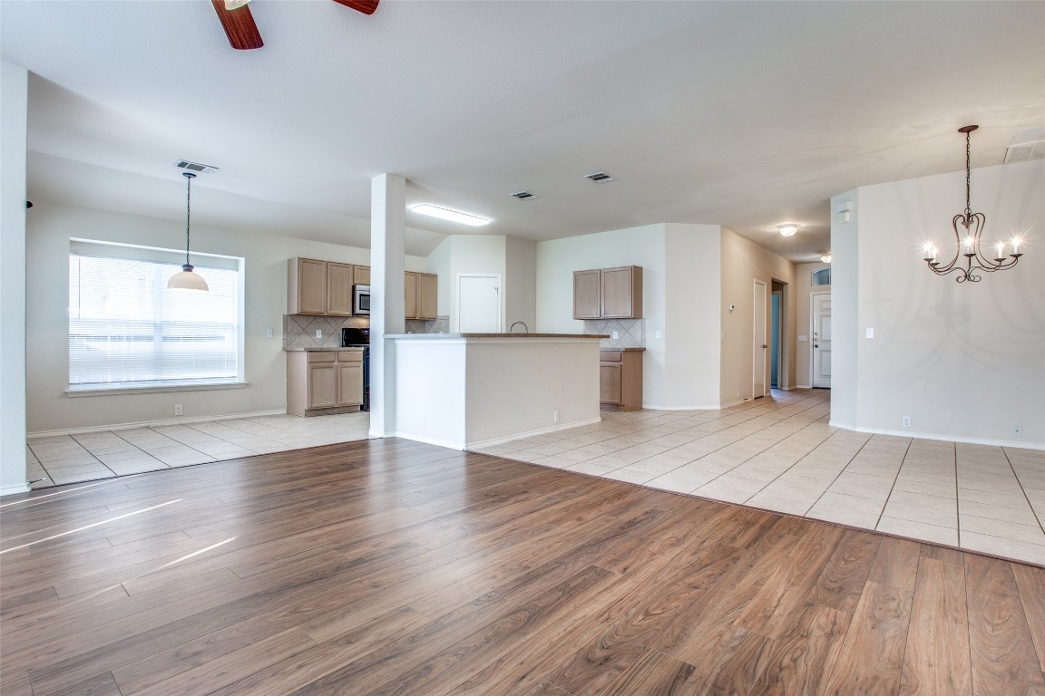 Undisclosed Address Round Rock, TX 78665 - Photo 12 of 25 a view of a kitchen with a fridge and wooden floor