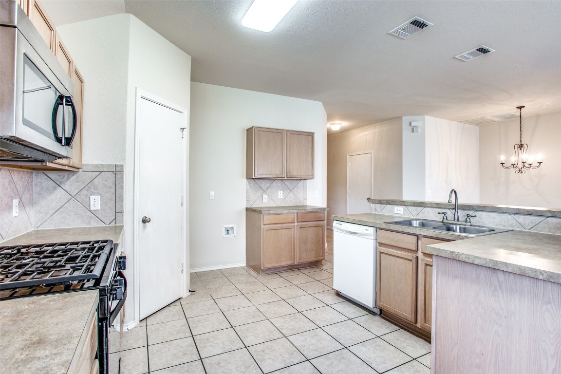 Undisclosed Address Round Rock, TX 78665 - Photo 17 of 25 a kitchen with a stove sink and cabinets