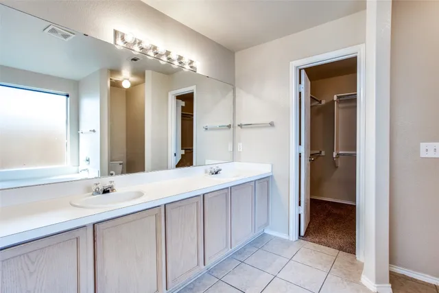 a bathroom with a double vanity sink and a mirror