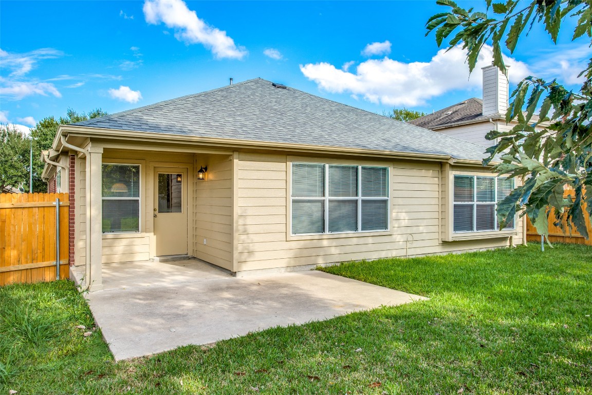 Undisclosed Address Round Rock, TX 78665 - Photo 24 of 25 a front view of a house with a garden and yard