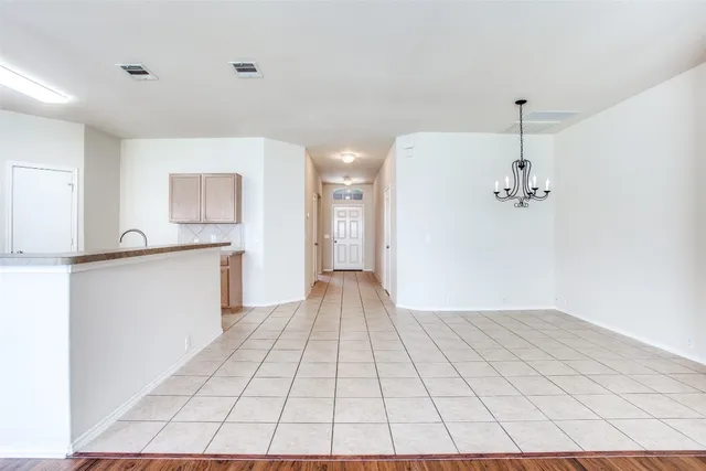 a view of a kitchen with a sink and a refrigerator