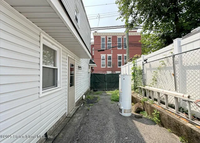 a view of a chair and table in backyard