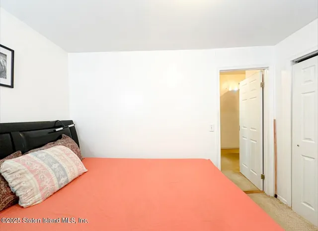 a bedroom with a bed and a painting