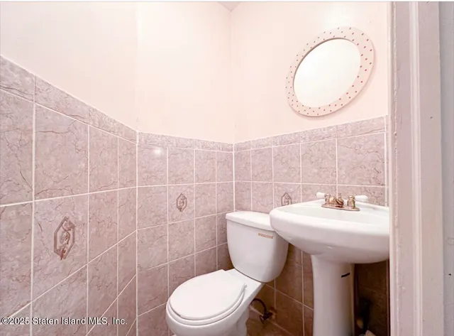 a living room with furniture and painting on the wall