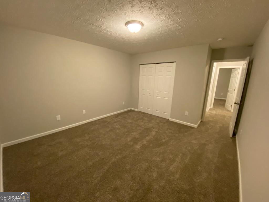 234 Temple Terrace Temple, GA 30179 - Photo 11 of 17 an empty room with a bench